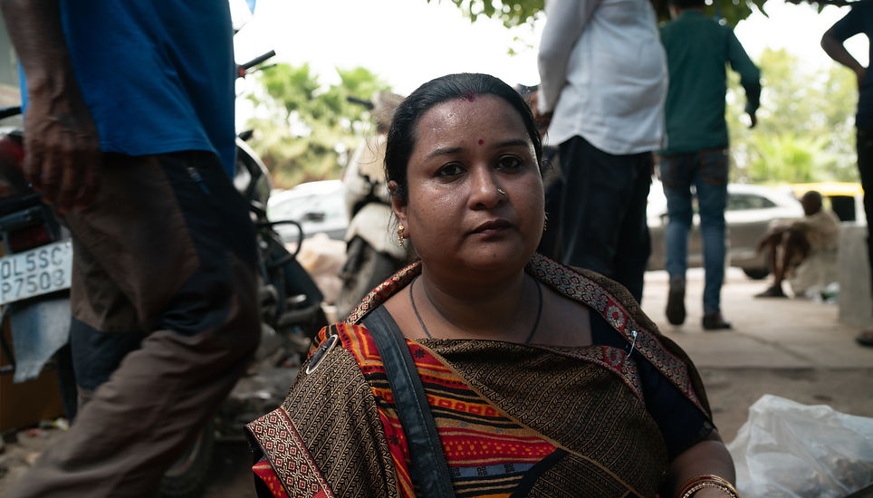 Woman sitting selling dry fruits in the heat