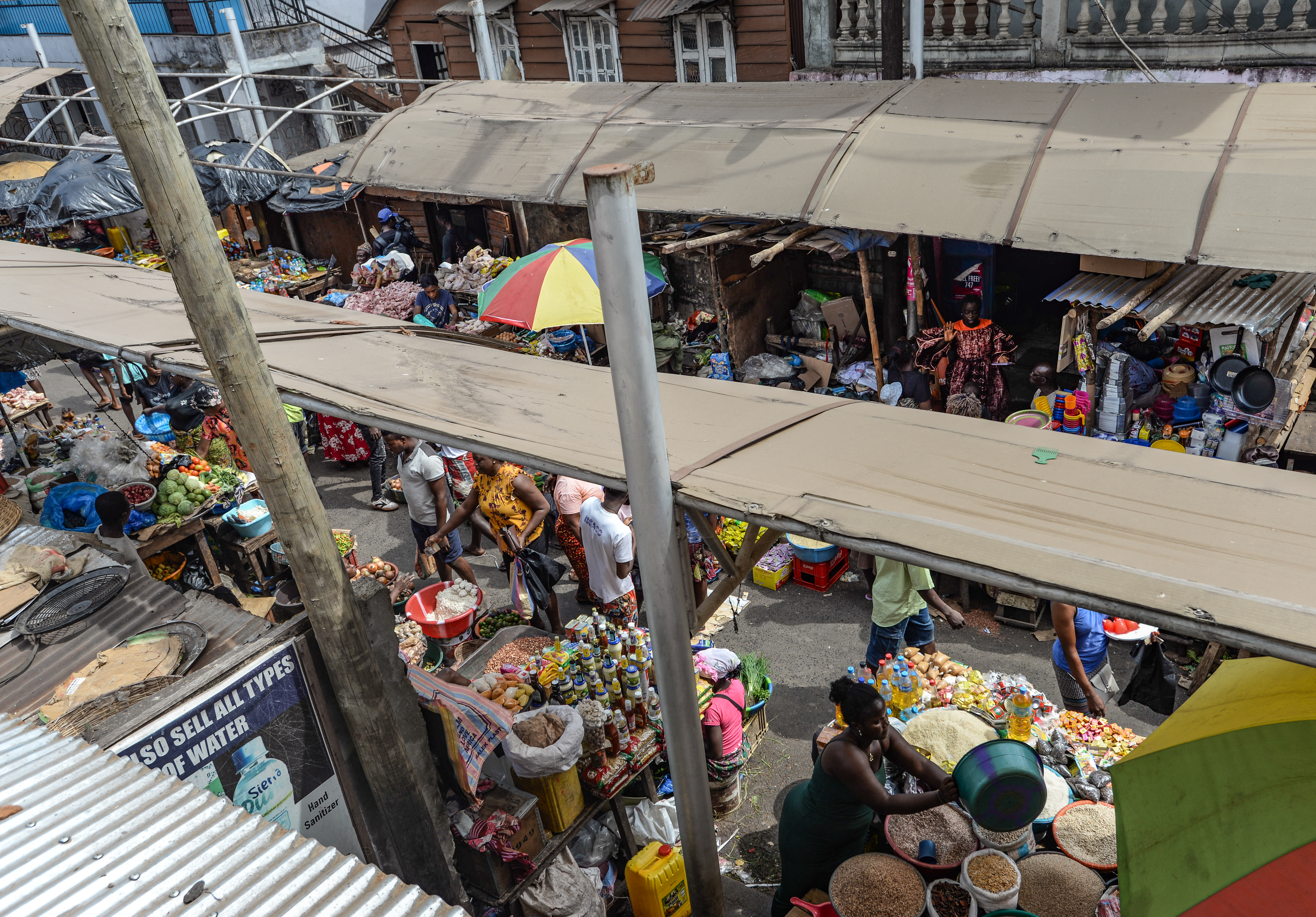 Sun shades, with sections missing after a storm, provide relief for vendors in Freetown's Congo market, January 11, 2025. CRA/Olivia Acland