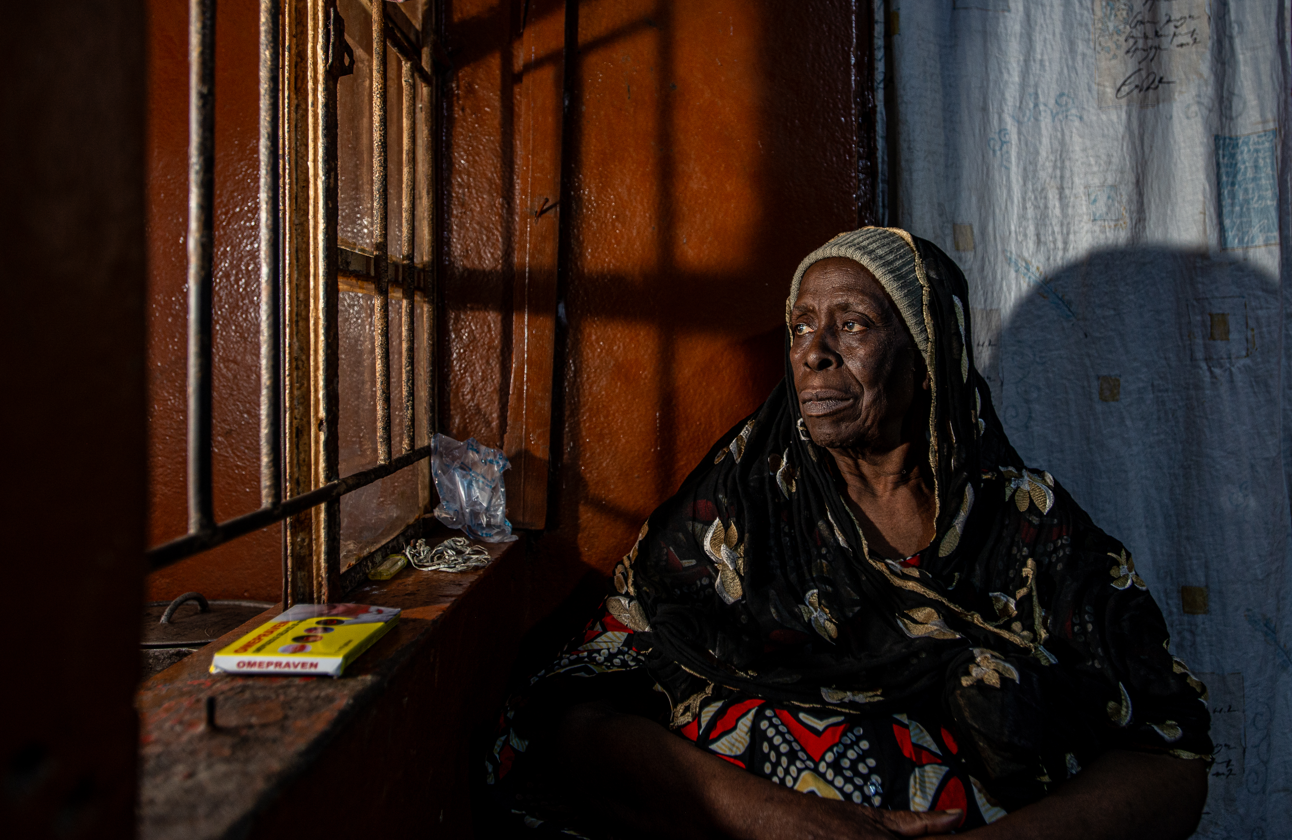 Local chief Ya Alimamy Fofanah sits in her home in a street behind a busy market in Freetown, Sierra Leone, February 11, 2025. CRA/Olivia Acland