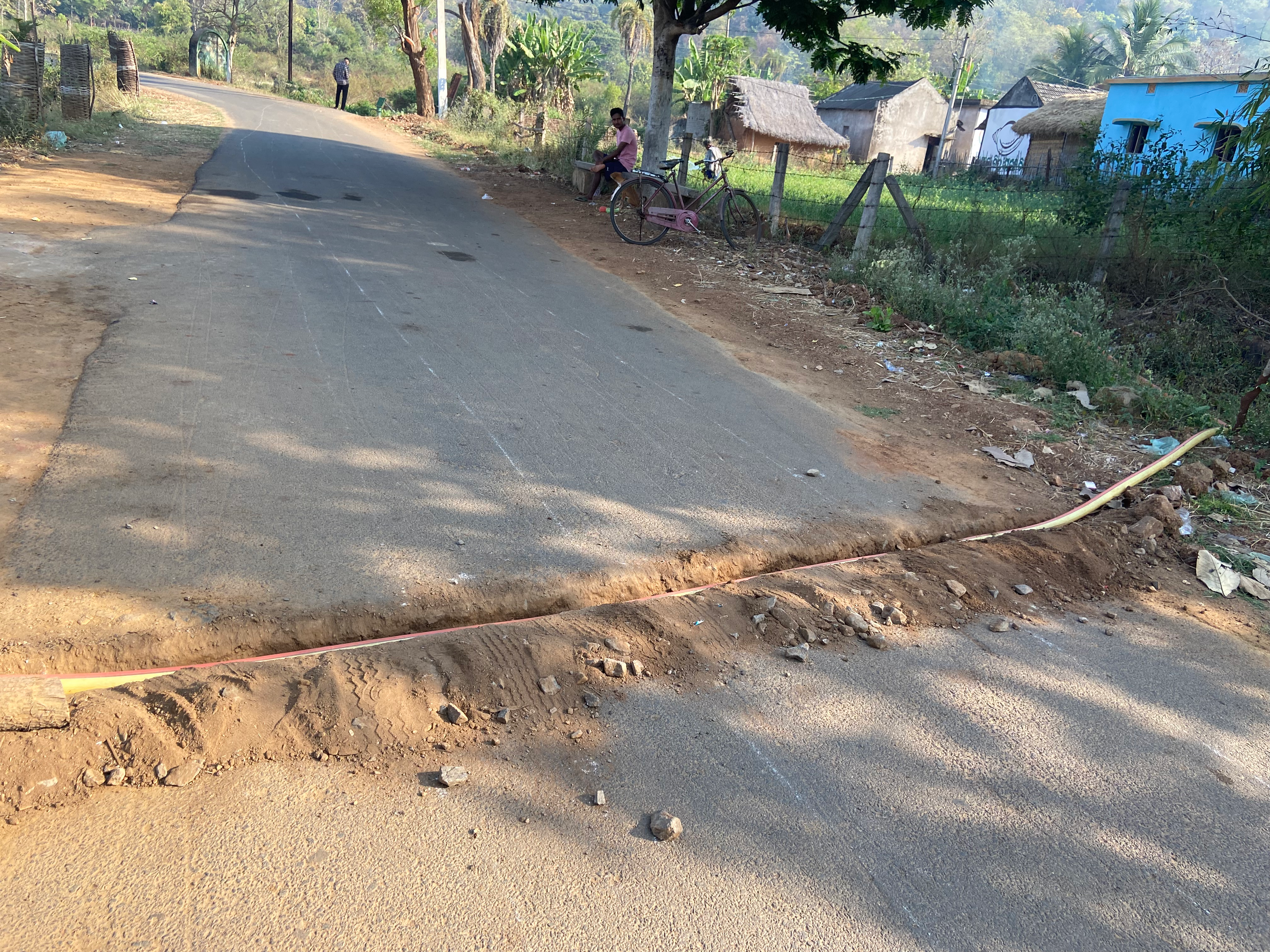 A water pipe laid across the road to connect wells and farms in the village of Bhagatpur, in India’s Odisha state, on March 1, 2025. Roli Srivastava/The Migration Story