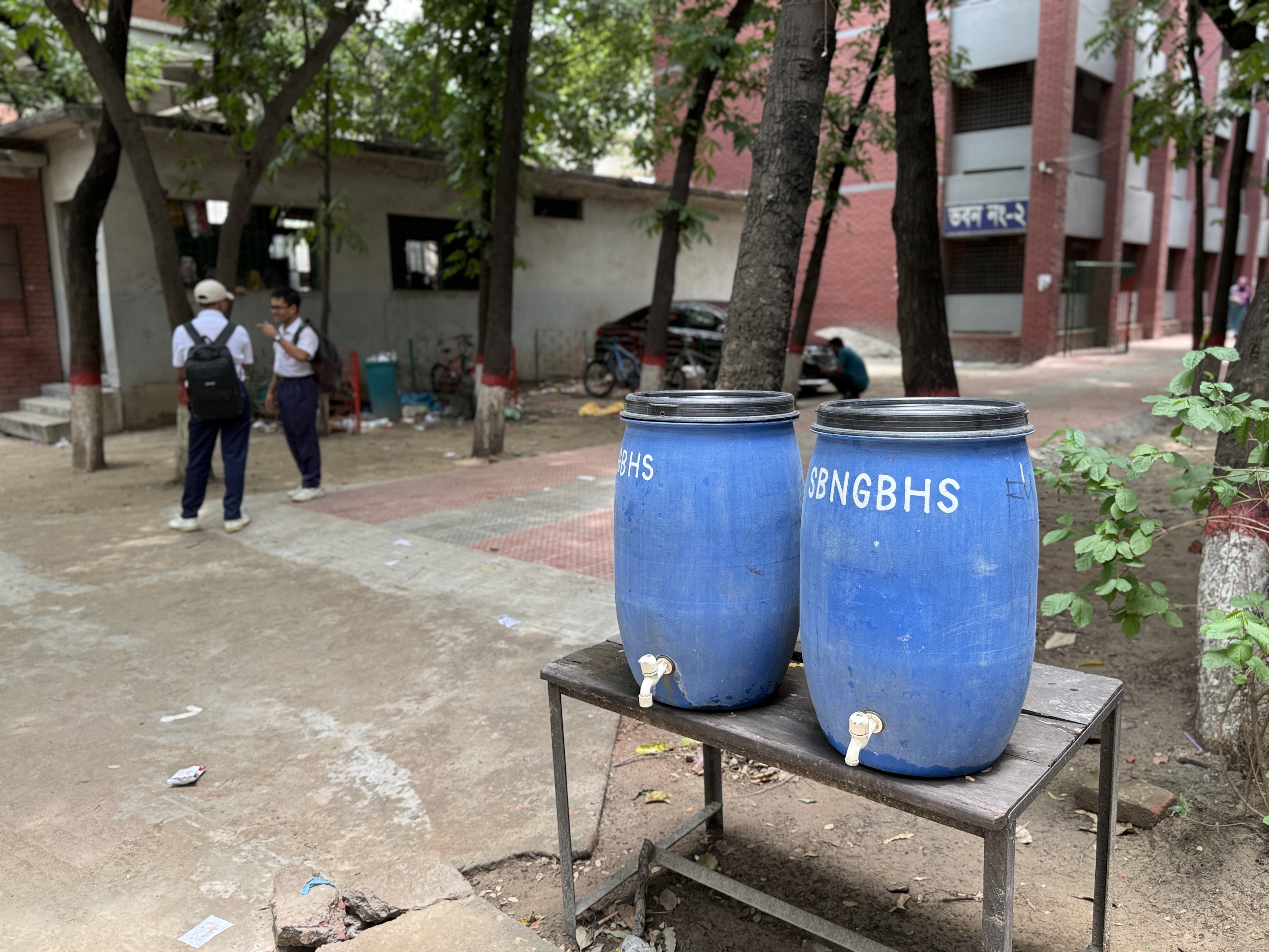 A school supplies containers of water for students to drink and splash their faces in hot weather in Dhaka, Bangladesh, May 29, 2025. Mosabber Hossain/Climate Resilience for All