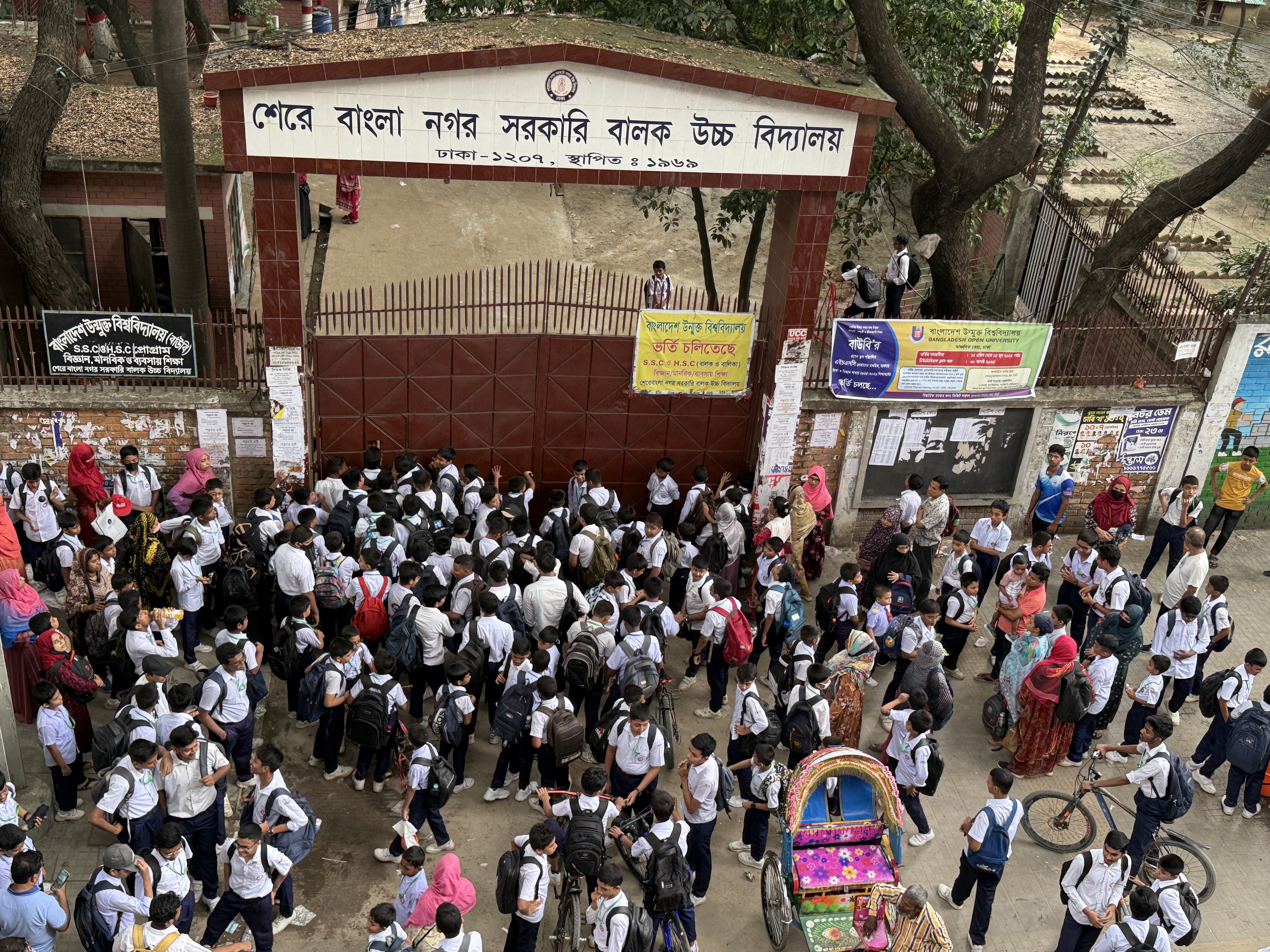 Students wait outside the gates of a school for the mid-day change of shifts in Agargaon, a district of Dhaka, Bangladesh, on May 29, 2025. Mosabber Hossain/Climate Resilience for All
