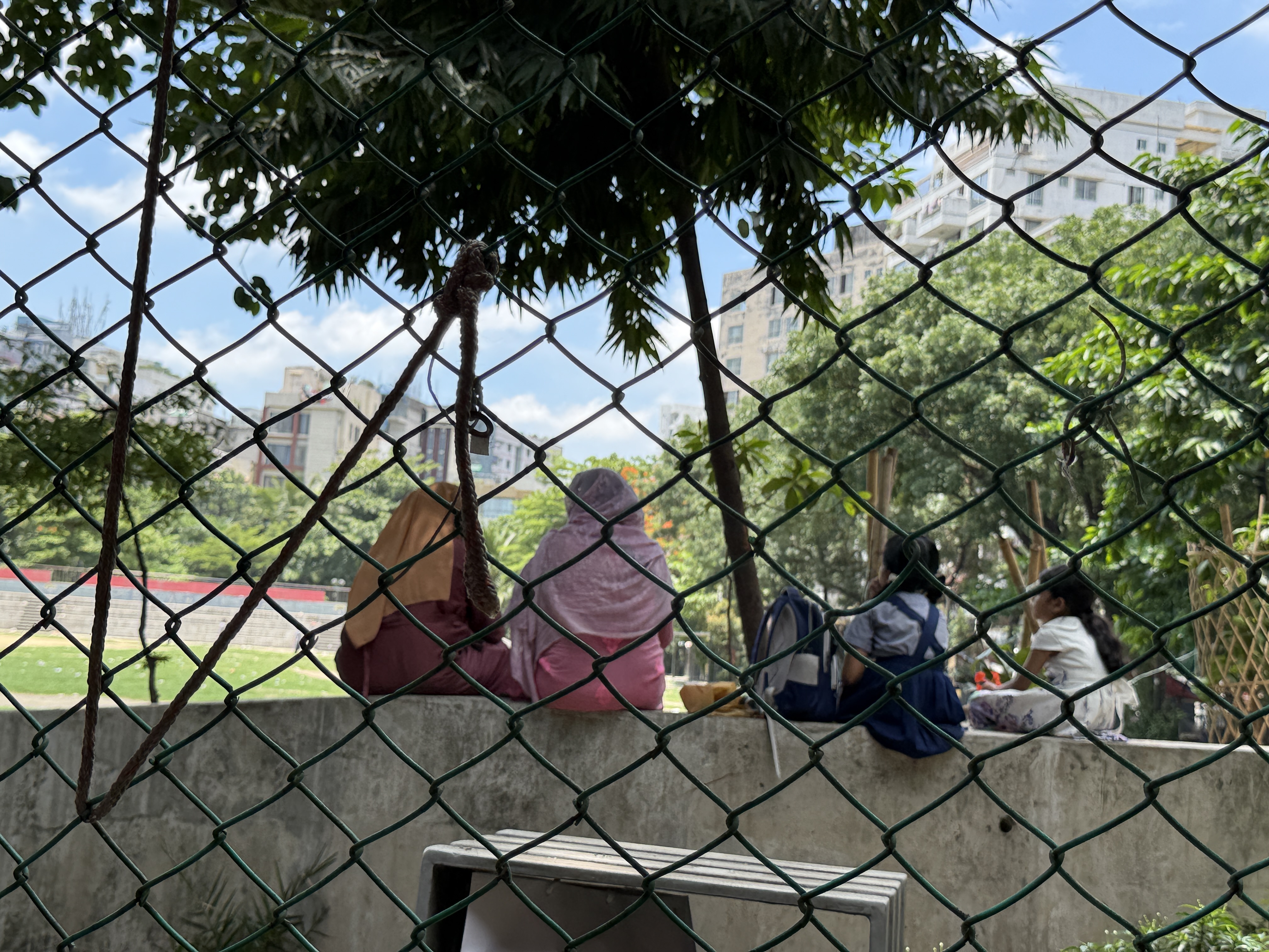 Heat-exhausted mothers and their daughters rest in a park near Government Jamila Ayeenul Ananda School & College in Dhaka, Bangladesh, May 29, 2025. Mosabber Hossain/Climate Resilience for All