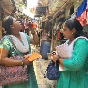 Health workers Anjali Girkar and Swati Kurne take a break to hydrate themselves while doing a survey on a hot day in April, 2025. Amitha Balachandra/Climate Resilience for All