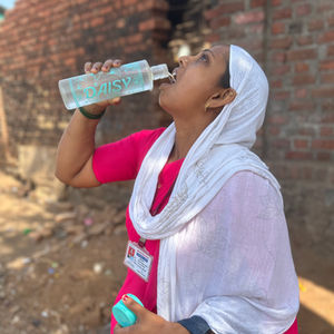 Health worker Vishaka Patil stops to drink water on a hot day during her field work in Maharashtra’s Khanivali village in May, 2025. Amitha Balachandra/Climate Resilience for All