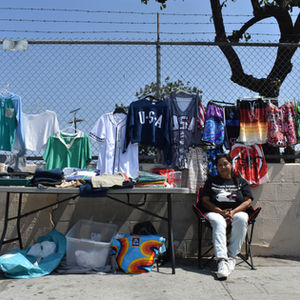 Patty Archuleta sits with her wares on an unshaded corner of San Pedro Street in the Historic South Central neighborhood of Los Angeles, California, on September 14, 2025. Climate Resilience for All/Rachel Parsons