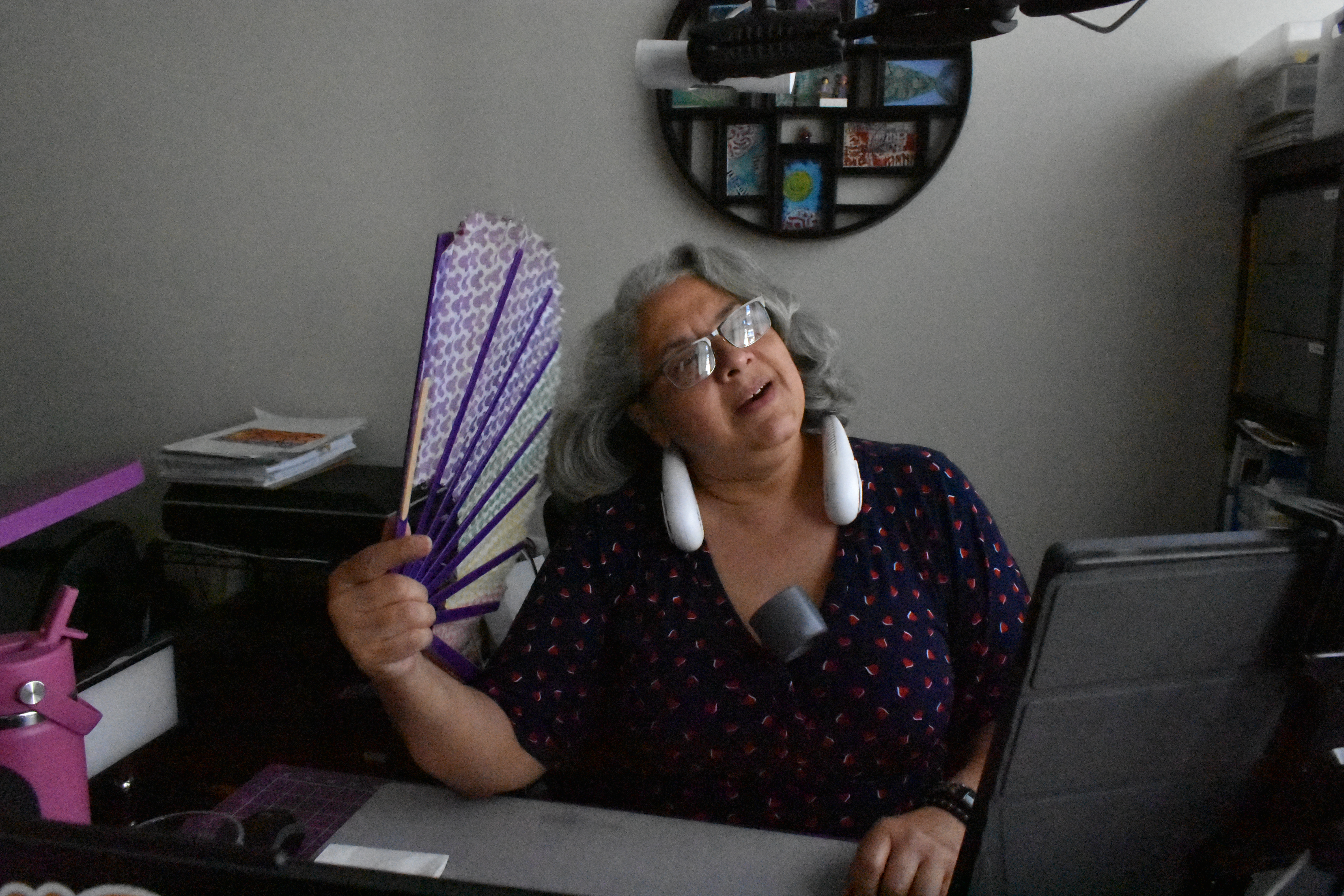 Estella Banks uses a few of the personal fans that help keep her cool while working at home in Los Angeles County, October 30, 2025. Climate Resilience for All/Rachel Parsons