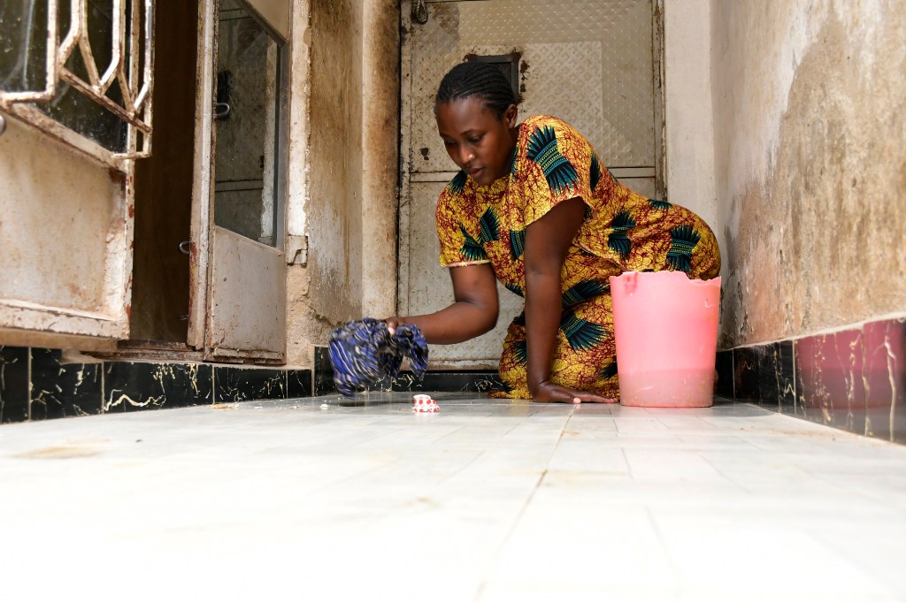 pregnant woman washing floor