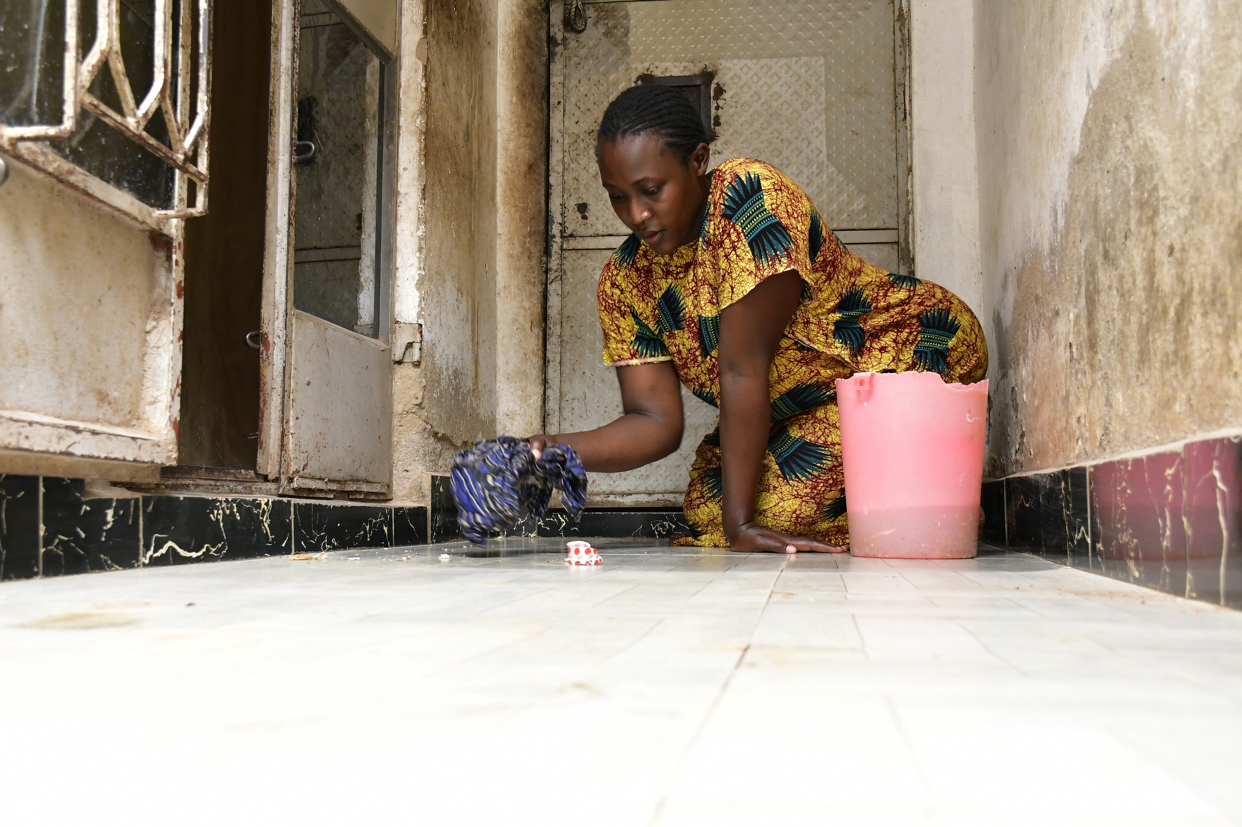 pregnant woman washing floor