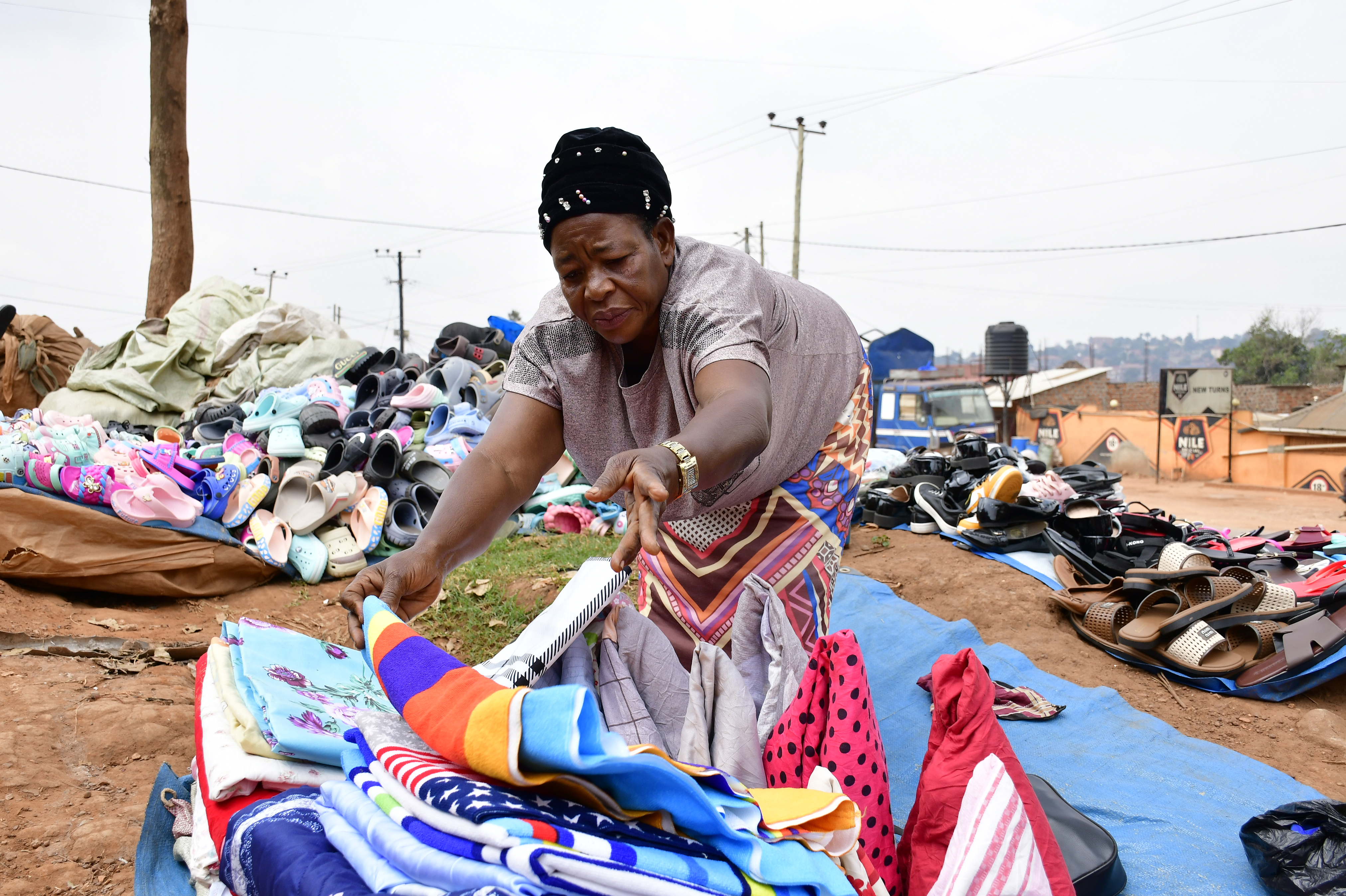 Margret Nalubega, a market vendor in Mpererwe, a suburb of Kampala, Uganda, arranges her wares, February 27, 2026. Abubaker Lubowa/HERA
