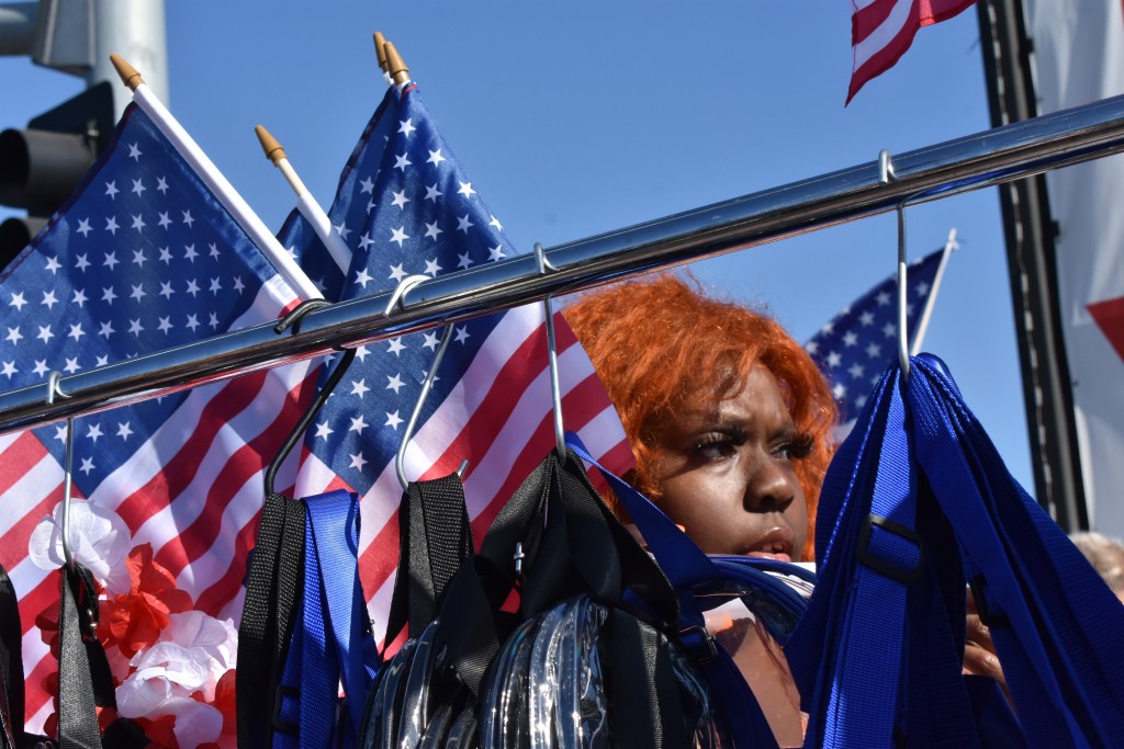 Street vendor Quesha Gillings sells bags, T-shirts and hats outside Los Angeles Stadium during a World Cup match