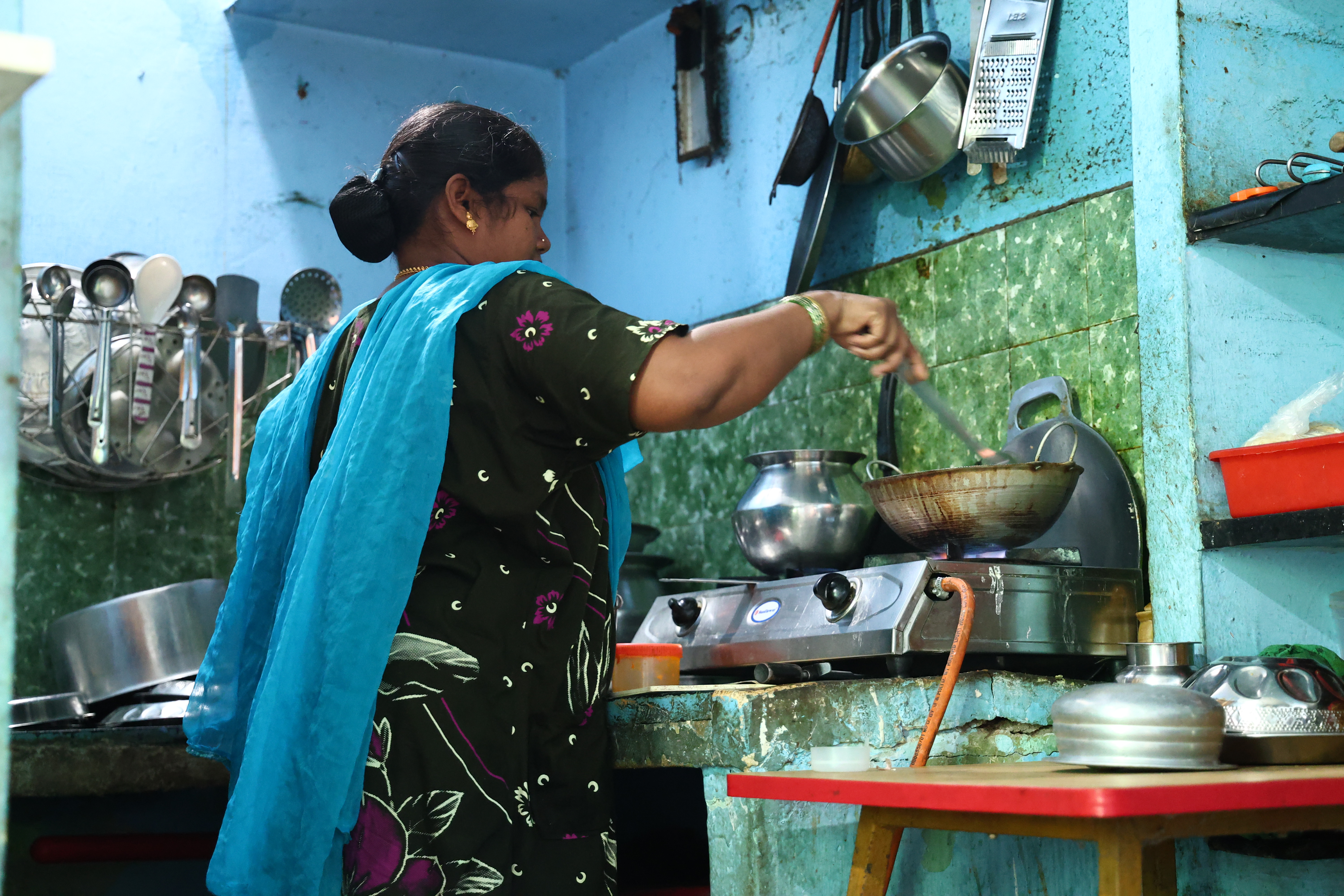 A.Induja cooks in a kitchen with no windows or exhaust fan in Chennai, India, June 19, 2026. HERA/K Balaram Bekay