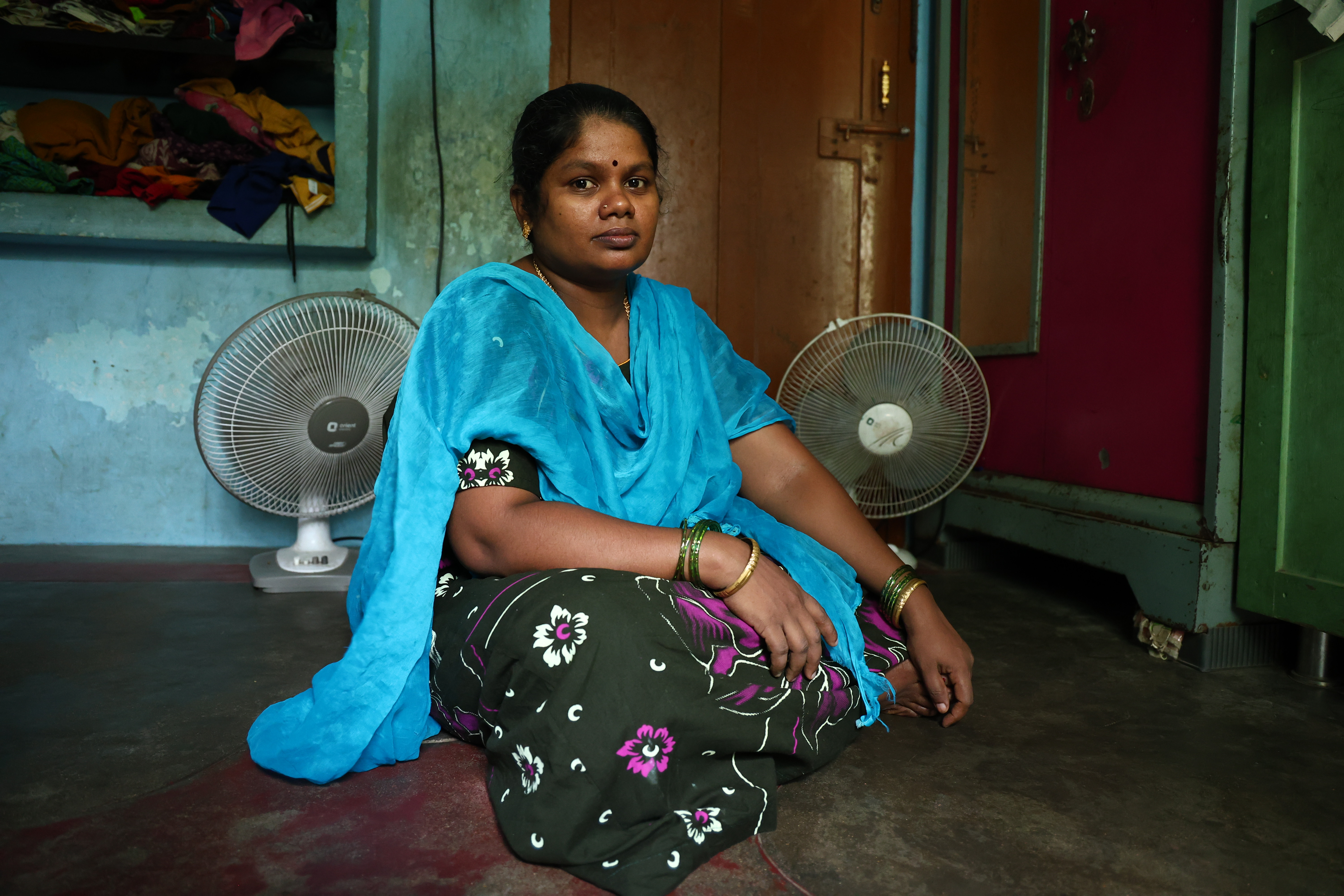 A.Induja rests in front of fans after cooking in Chennai, India, June 19, 2026. HERA/K Balaram Bekay
